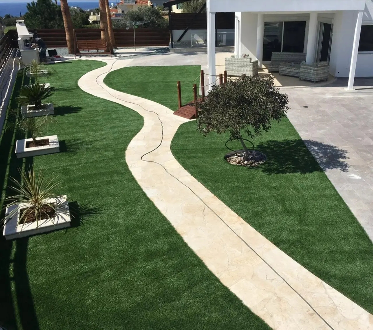Artificial lawn with a curving stone path