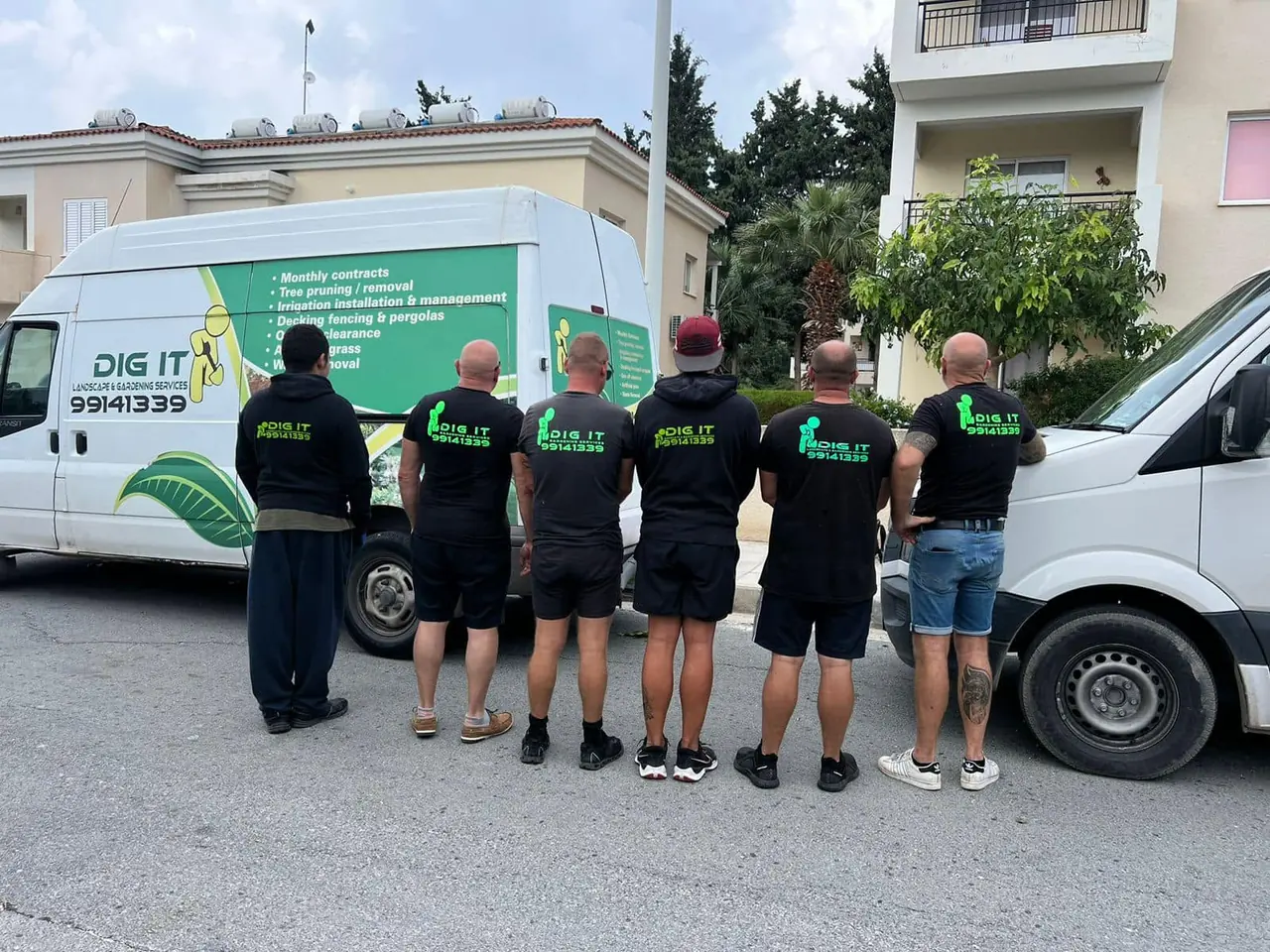The Dig it crew lined up in uniform beside the van