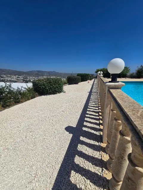 Gravel walkway beside the pool