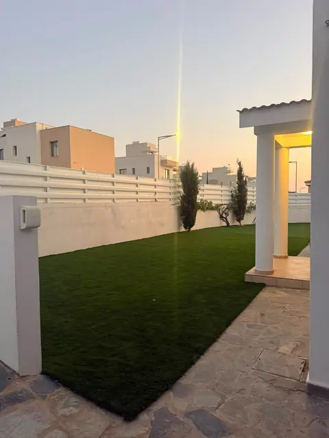 New artificial lawn at sunset