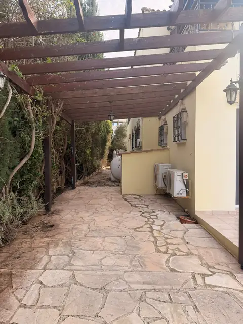 A pergola path cleared and swept